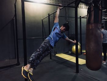 Full length of young man hanging at home