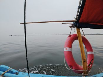 Close-up of sailboat on sea against sky
