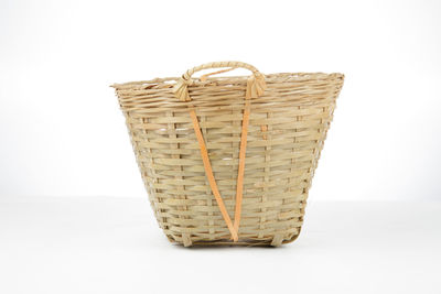 Close-up of wicker basket on white background