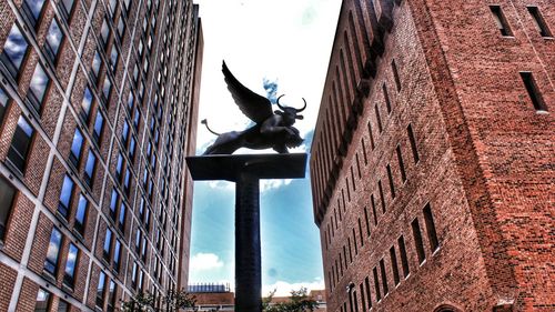 Low angle view of statue against building