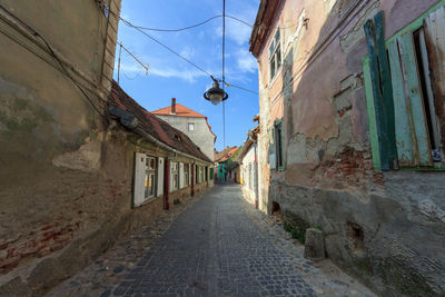 Empty alley amidst buildings in town