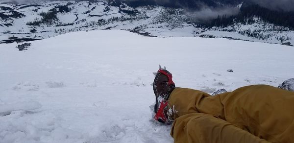 Person on snow covered field against snowcapped mountains