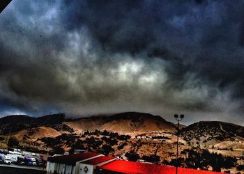 Houses against cloudy sky