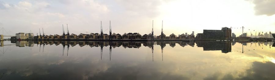 Panoramic view of lake and buildings against sky