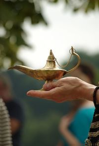 Close-up of hand holding magic lamp