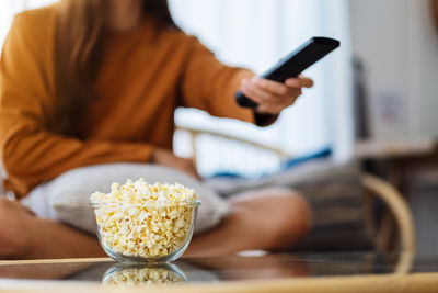 Midsection of woman using mobile phone