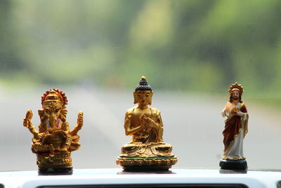 Close-up of statues on car windshield