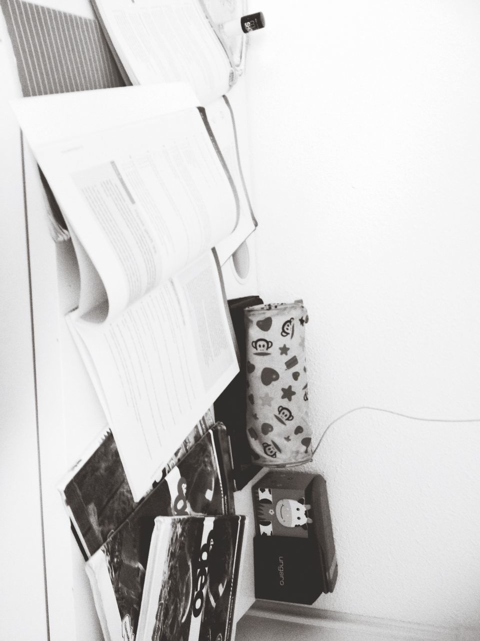 indoors, paper, table, book, still life, communication, technology, close-up, education, high angle view, text, no people, document, equipment, home interior, wall - building feature, music, wireless technology, desk, connection