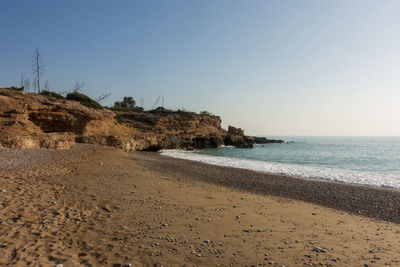 Scenic view of beach against clear sky