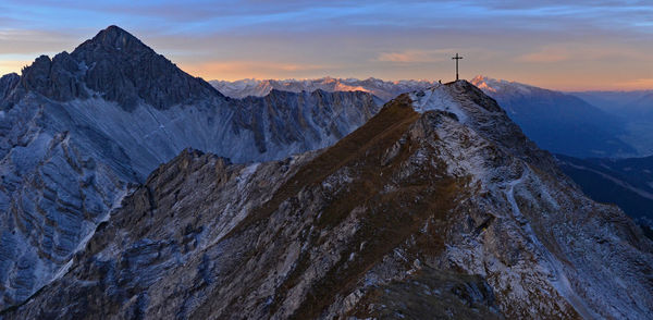 Scenic view of snowcapped mountains against sky during sunset