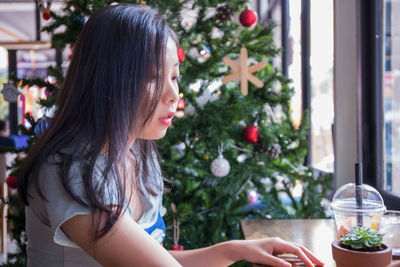 Woman looking at christmas tree