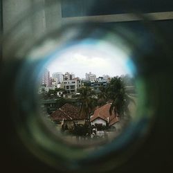 Cityscape against sky seen through window