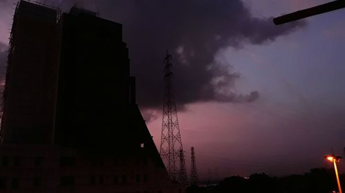 Low angle view of silhouette buildings against sky at dusk