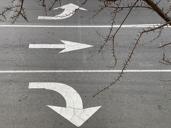 High angle view of arrow symbols on road