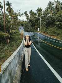 Full length of young man standing on road