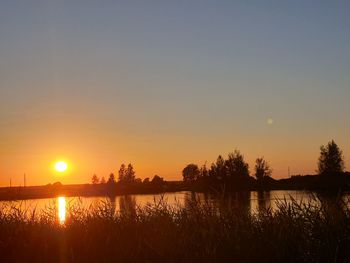 Scenic view of lake against sky during sunset