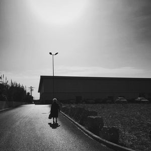 Rear view of a man walking on road