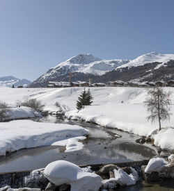 Scenic view of snowcapped mountains against clear sky