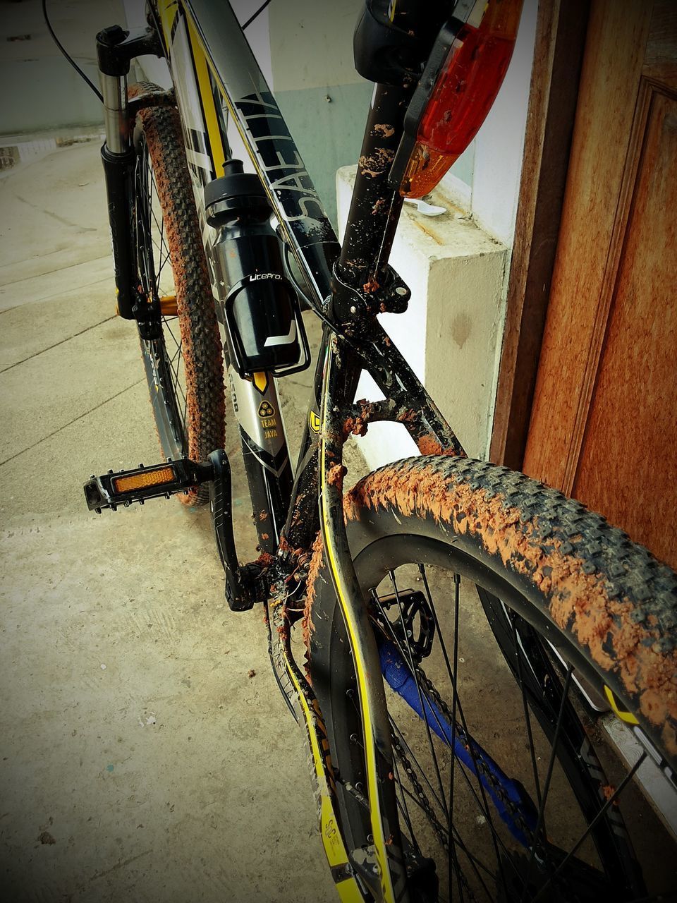 CLOSE-UP OF BICYCLE WHEEL IN HIGH ANGLE VIEW OF BICYCLES