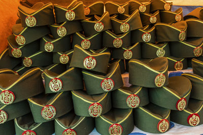 Full frame shot of stacked uniform caps