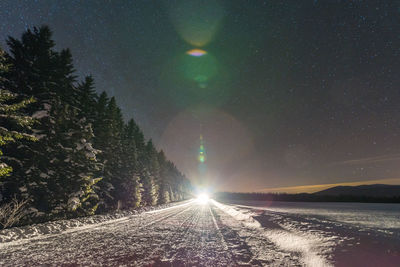 Scenic view of snow against sky at night