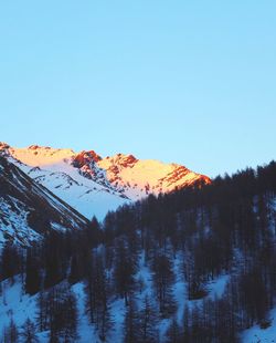 Scenic view of snowcapped mountains against clear sky