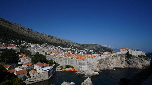 Town against clear blue sky