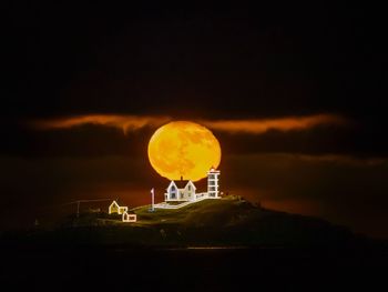 Scenic view of factory against sky at night