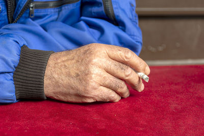 Midsection of woman with hands on table