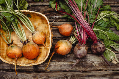 High angle view of vegetables. yellow and pink beetroots on rustic wooden background