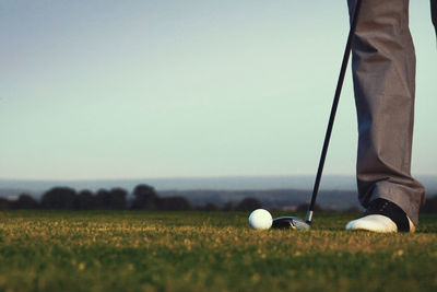 Low section of man standing on golf course