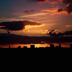 Silhouette of city at sunset