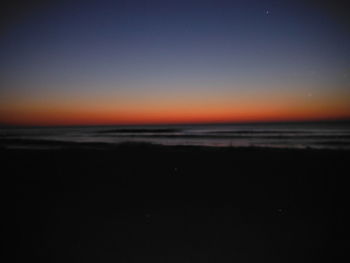 Scenic view of sea against clear sky at sunset