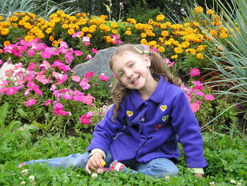 Portrait of smiling girl against flowers