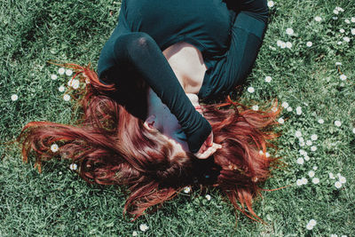 High angle view of woman relaxing on field