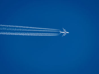 Airplane flying against blue sky