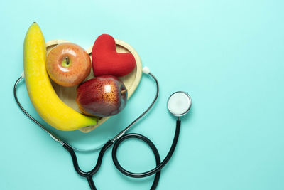 High angle view of apples on table against blue background