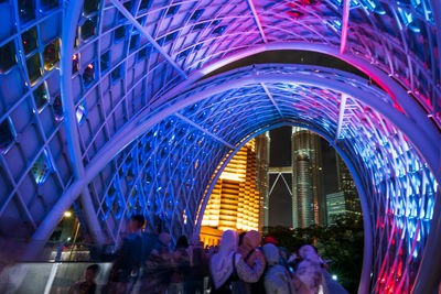 People in illuminated modern building