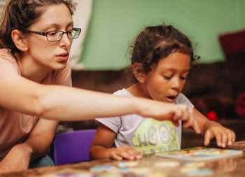 Mother assisting daughter in studies at home