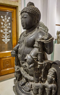 Statue of buddha against building