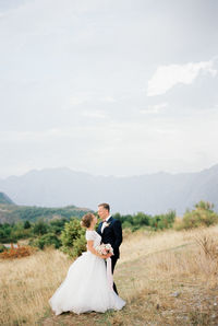 Rear view of bride holding bouquet