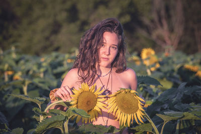Beautiful young woman with yellow flower