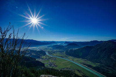 Scenic view of landscape against bright sun