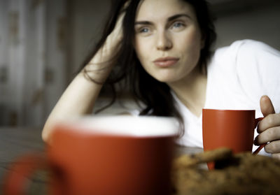 Young woman using mobile phone at home