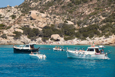 Sailboats moored on sea