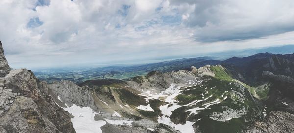 Scenic view of sea and mountains against sky