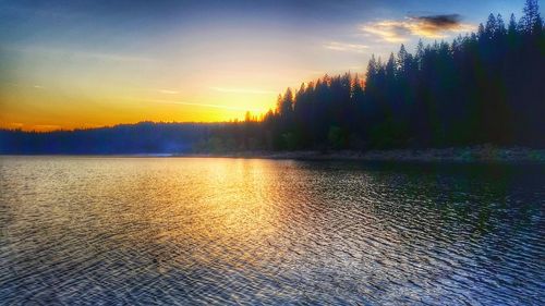 Scenic view of lake at sunset