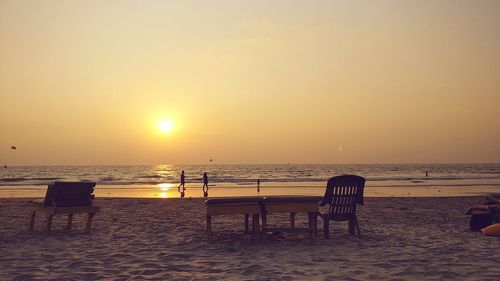 Scenic view of beach against clear sky during sunset