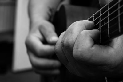 Close-up of man playing guitar