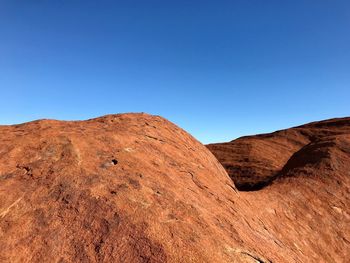Scenic view of rocky mountains against clear blue sky